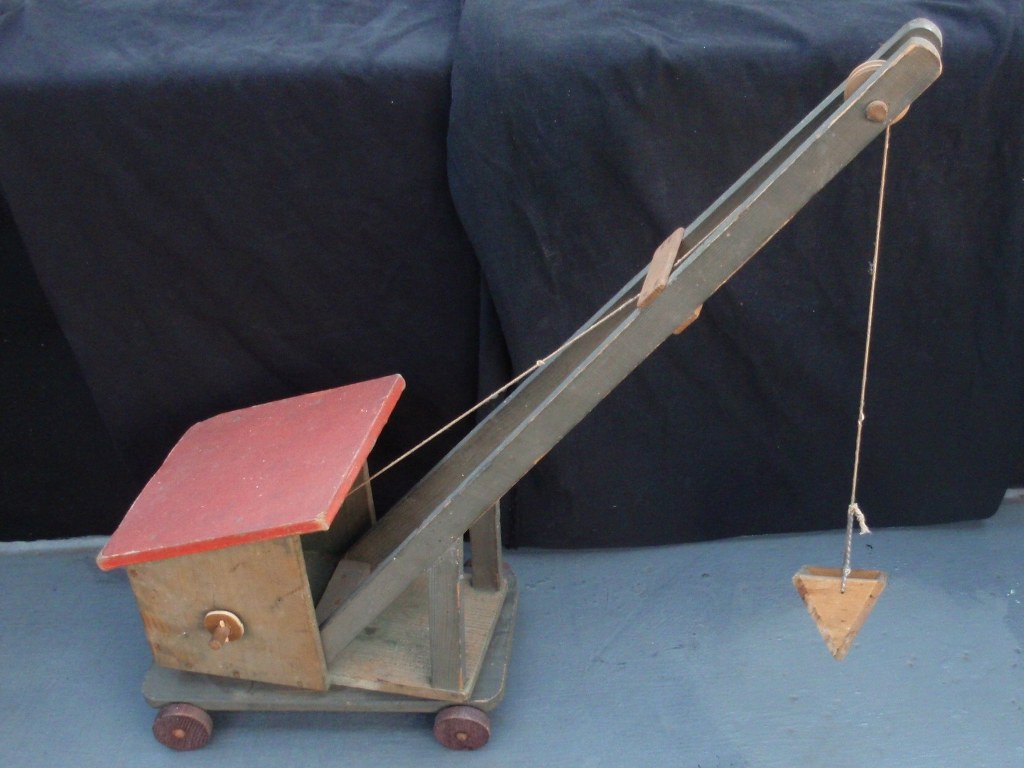 Wooden fifties toy crane on wheels