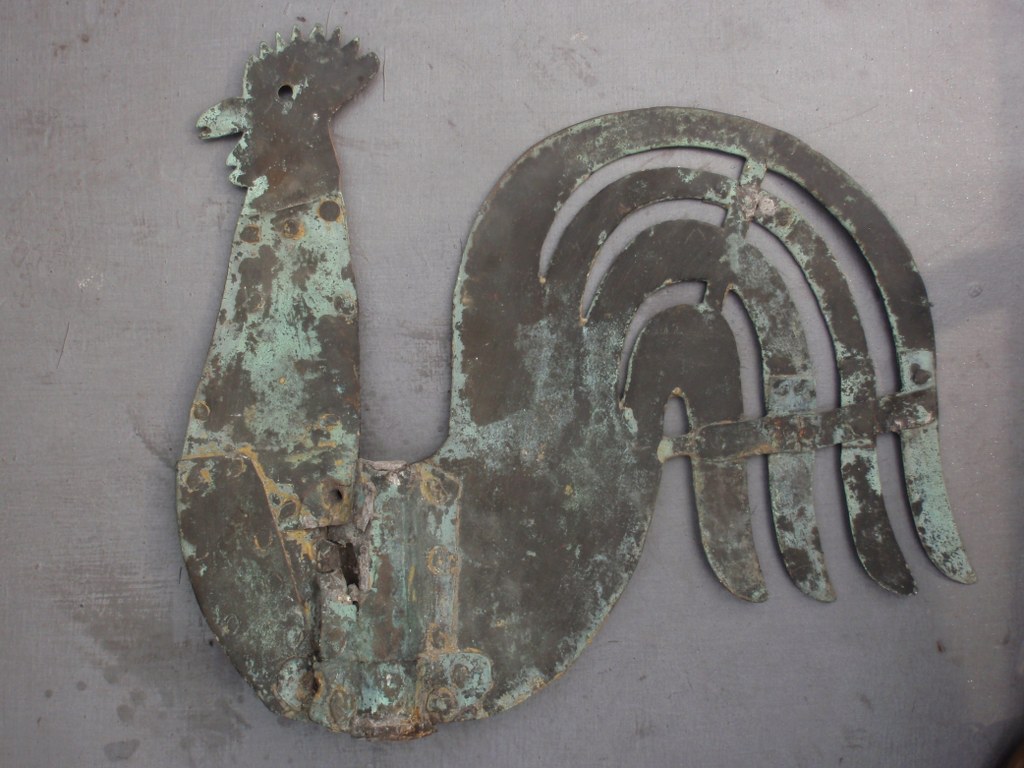 Antique weather vane in the shape of a cock