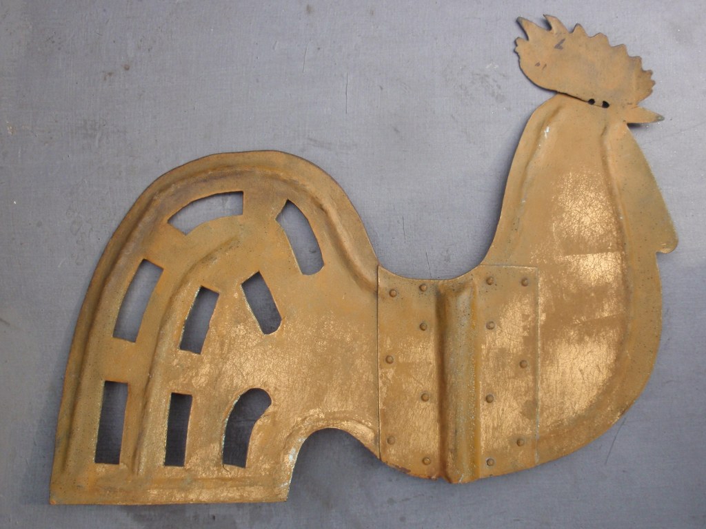 Vintage weather vane in the shape of a cock 